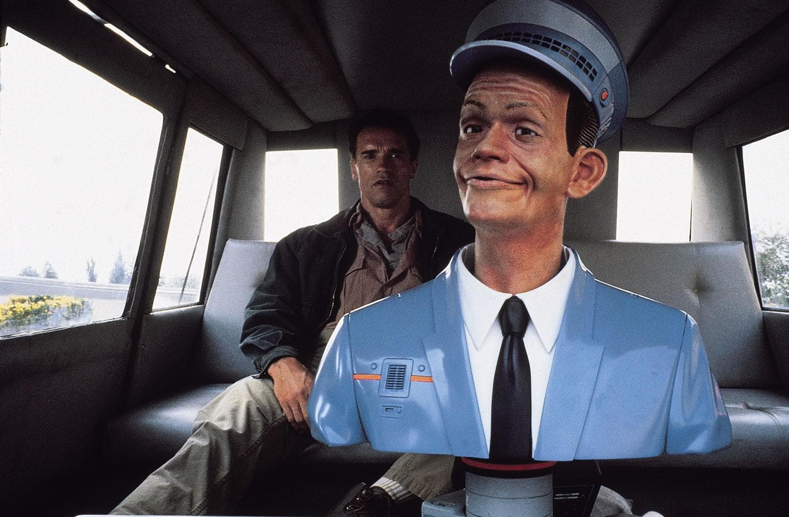 In Total Recall (1990) Johnny Cab has a small vent visible on his upper  torso during the cab scene. This is foreshadowing the later reveal he was  in fact a robot all